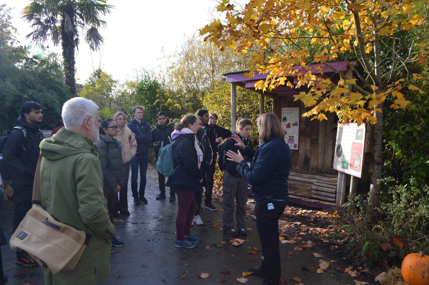 A group of students at Chester Zoo listening to zoo staff explain behavioural recording