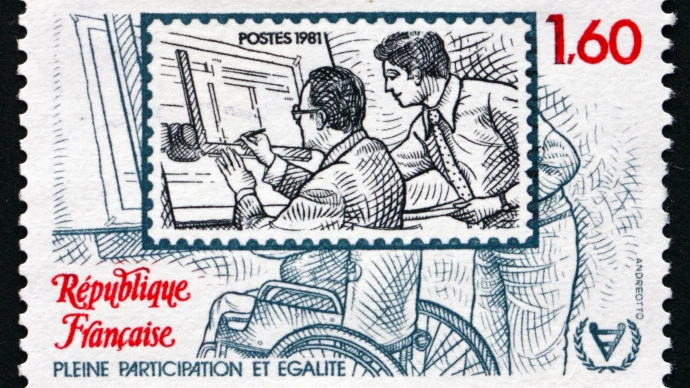 A French stamp showing a graphic designer in a wheelchair working at a draughting board commemorating the 1981 International Year of the Disabled