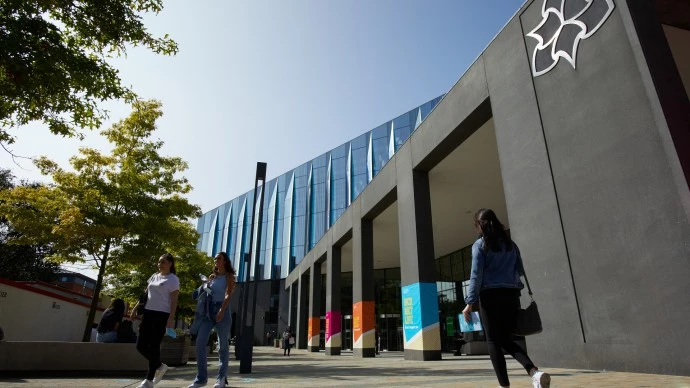 Outside the Business School with people walking in and out