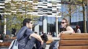 Students socialising in green space on campus