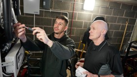 Engineers working on the electrics in a building basement